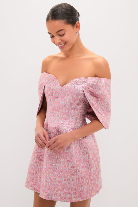 Young woman in a Pink Multi Jacquard Off-the-Shoulder Kara Midi Dress, smiling softly, showcasing an effortless, high-end look with classic, fun elegance.