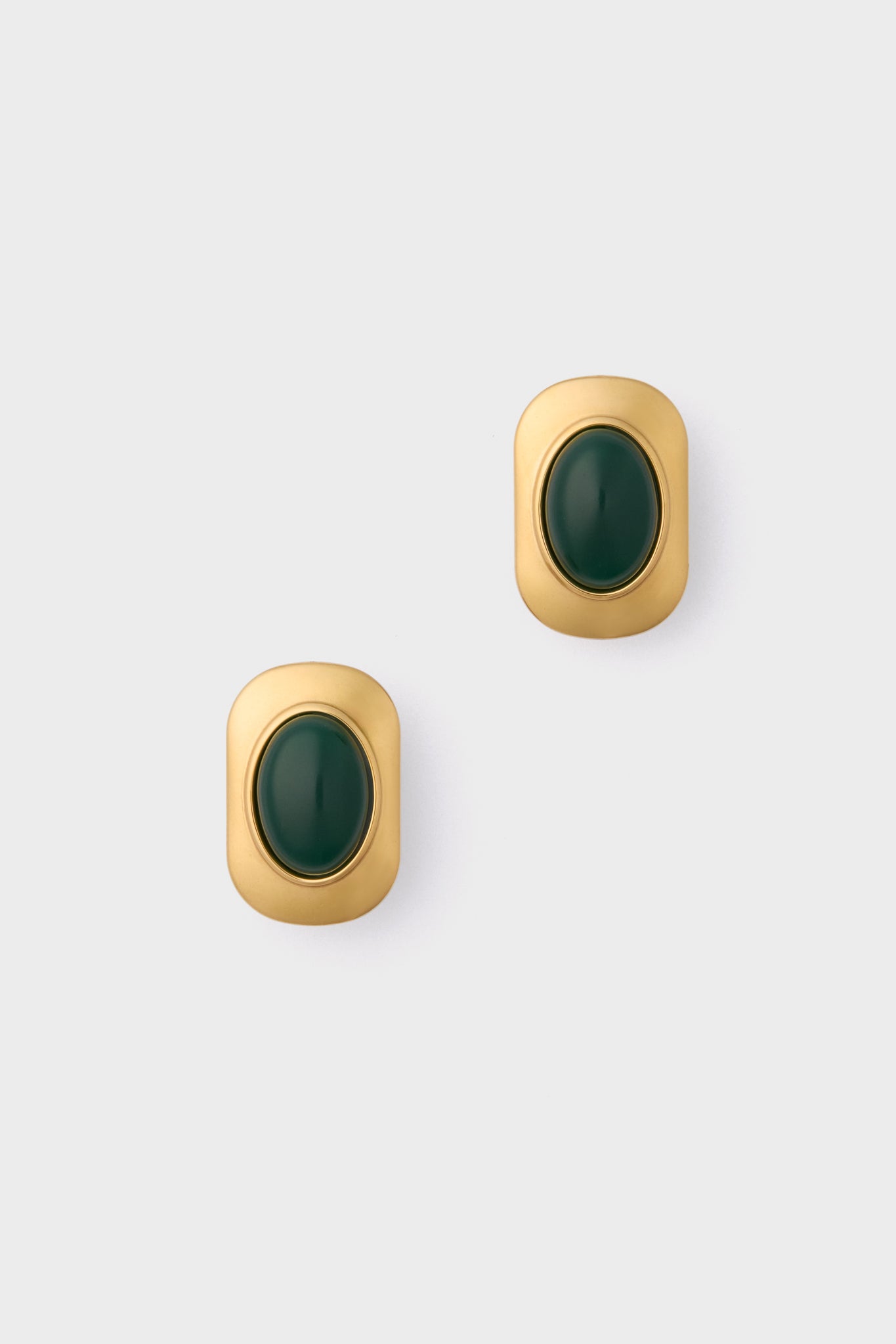 Petit Moments presents vintage-inspired gold-tone oversized studs with rounded edges, each adorned with a central dark green oval stone.