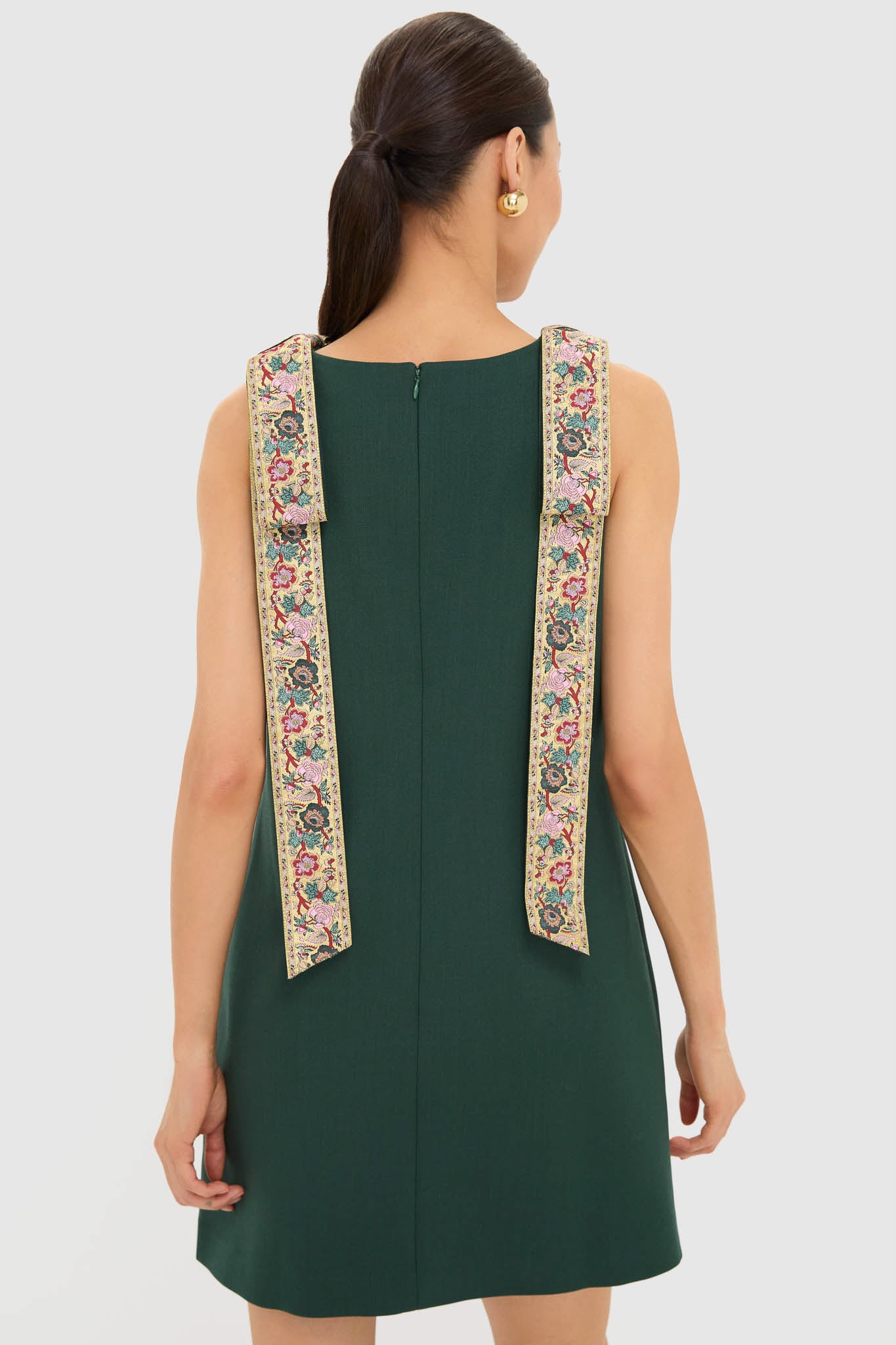 Model in classic, high-end Garden Scrollwork Jacquard Bow Rosie Dress, showcasing effortless elegance with tapestry-style shoulder straps and chic shift silhouette. Perfect for fun, stylish occasions.