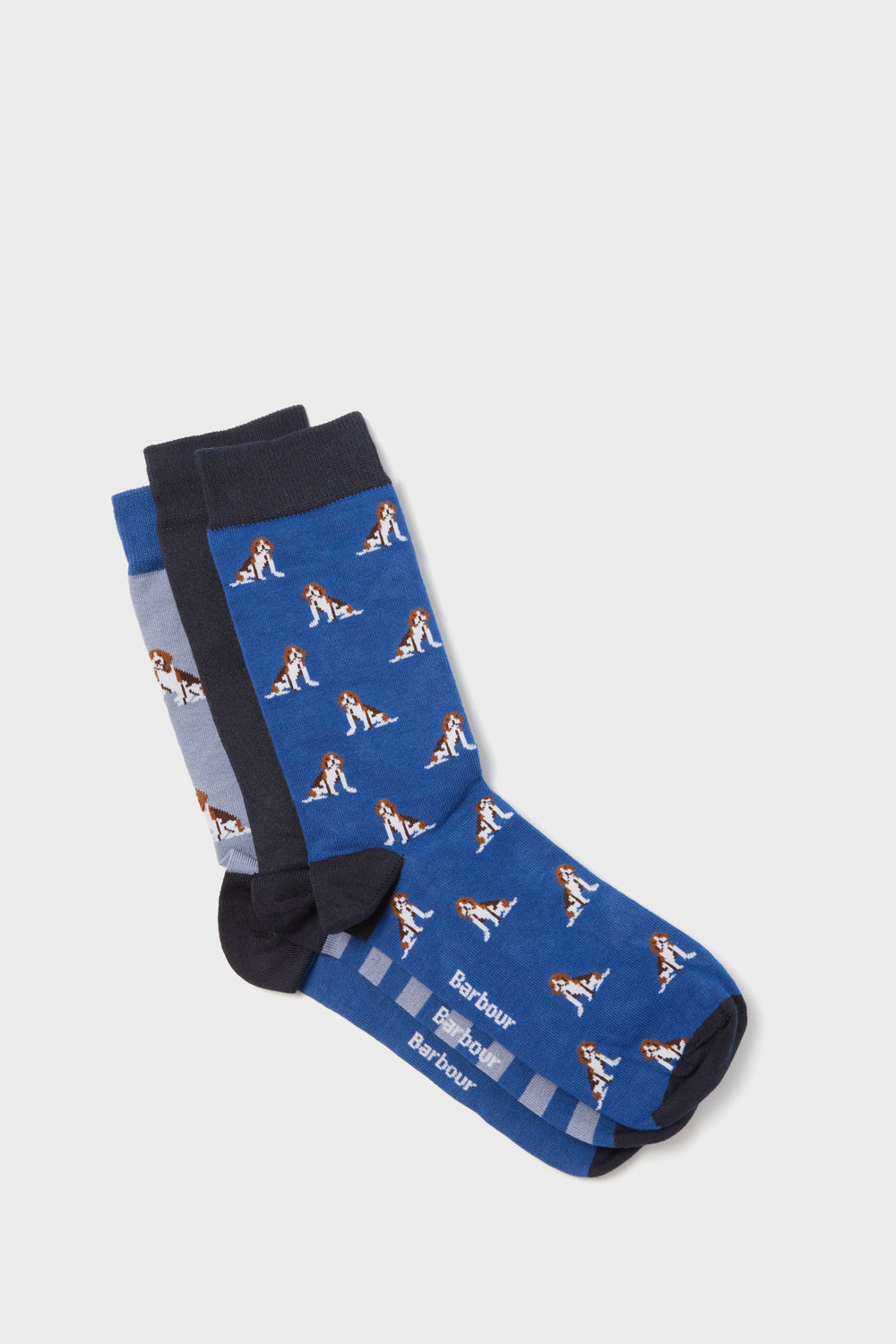 Three pairs of Barbour socks featuring a beagle dog motif are stacked together, highlighting blue, navy, and grey cotton-blend designs.