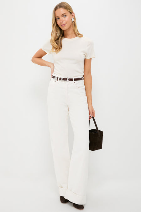 Model wears the Sepia Aiden Studded Rugous Belt, showcasing its sleek leather and silver buckle, adding a classic, effortless edge to her high-end ensemble.