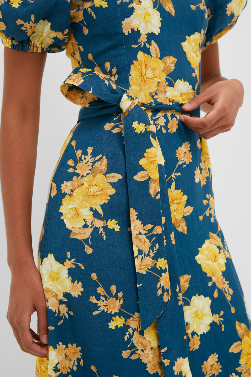 Nora Floral Navy Leiria Midi Dress: Effortlessly classic with puff sleeves and a self-tie belt, offering a fun yet high-end flair for any occasion.