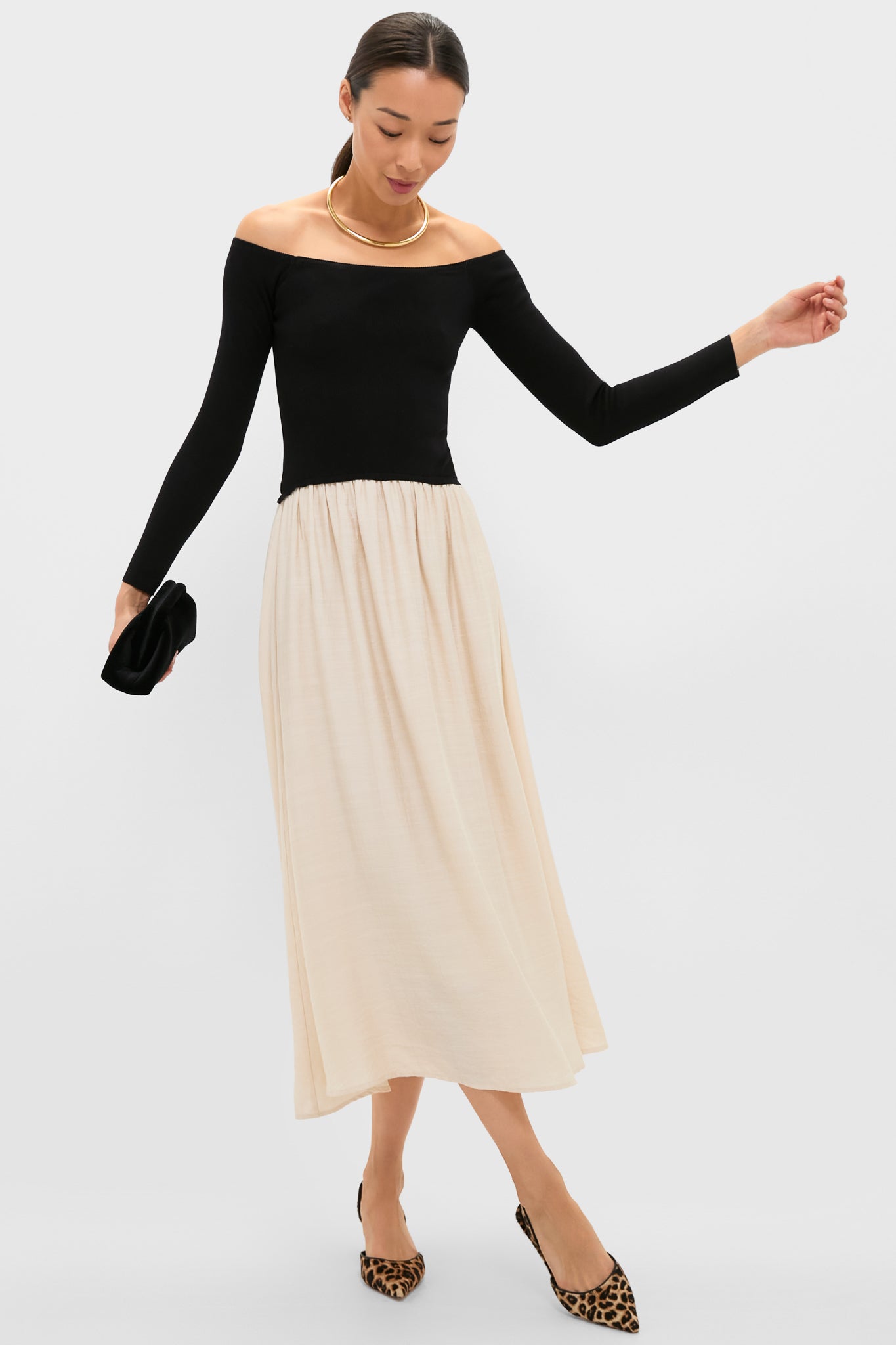 Leopard Caroline Heels: Classic and effortless suede slingbacks with a pointed toe, perfect for fun or high-end occasions, paired with a chic midi skirt and gold necklace.