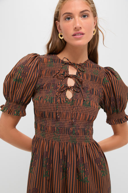 Model in the Multi Maribel Maxi Dress by Saylor, featuring classic smocked bodice, effortless puff sleeves, and fun lace-up keyhole neckline, embodying high-end style.