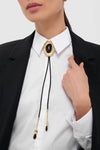 Classic Gold and Black Dolly Bolo Tie Necklace features a braided faux leather cord, gold-tone slide with black stone, offering an effortless, high-end style upgrade.