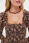 Woman wearing a classic, high-end Wood and Gold Beaded Necklace with a choker style, effortlessly blending natural wood beads and gold accents for a fun, versatile look.