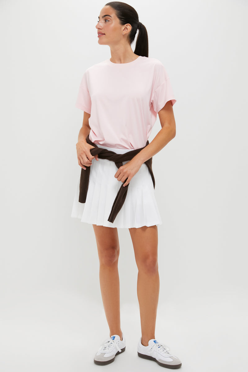 Young woman models the classic Pink Short Sleeve Performance Jersey Ryan Boyfriend Tee, featuring effortless style with a boxy fit, ideal for fun, high-end versatility.