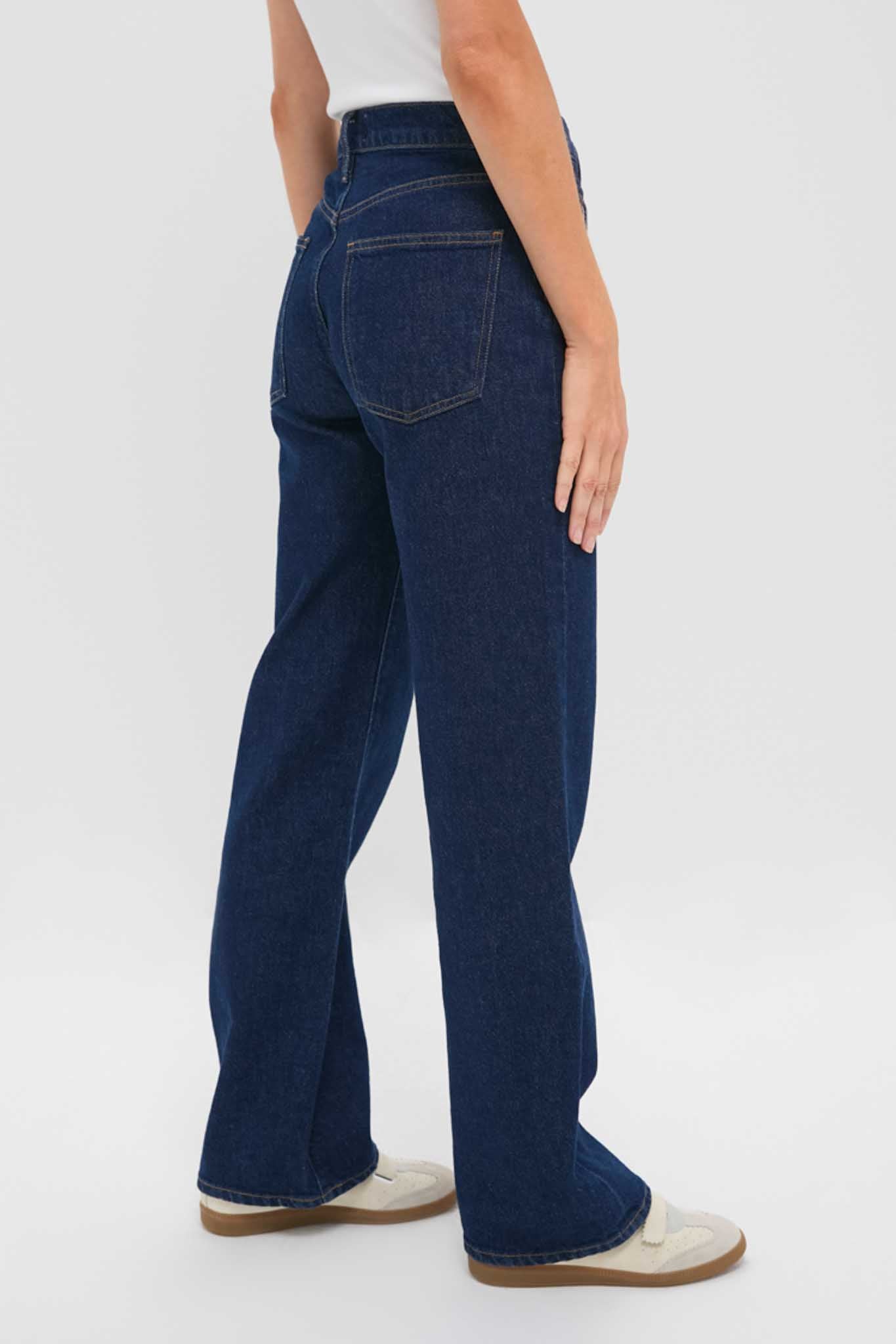 Reissue Mid Rise Relaxed Straight Harper Jean in dark indigo, featuring classic five-pocket styling and effortless straight leg, paired with cream sneakers for a fun, high-end look.
