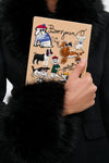 Latte Les Chiens Caramel Book Clutch: a classic, high-end canvas accessory with whimsical embroidered dogs and French words, perfect for adding effortless fun to any outfit.