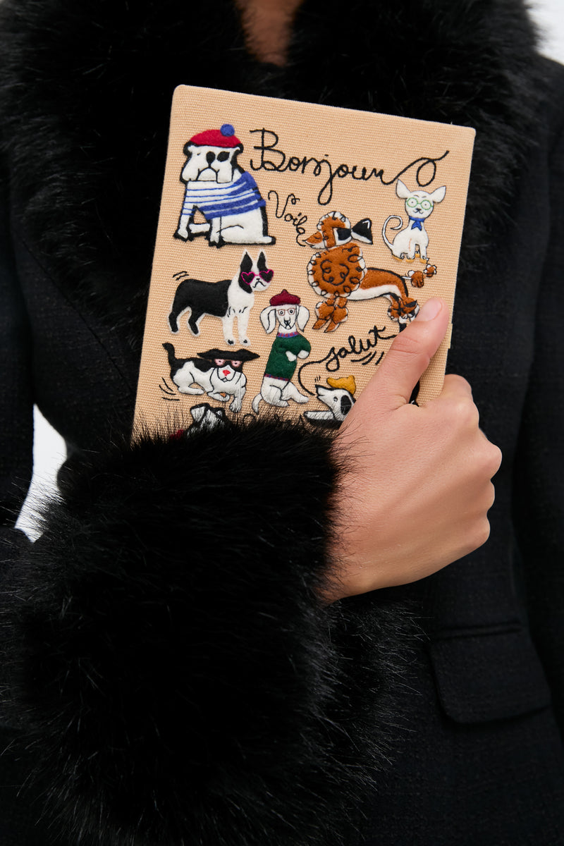 Latte Les Chiens Caramel Book Clutch: a classic, high-end canvas accessory with whimsical embroidered dogs and French words, perfect for adding effortless fun to any outfit.