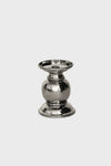 A small, polished silver candle holder with a rounded center, flat base, and decorative ridged edges—crafted in hammered stainless steel by Juliska for an elegant touch.
