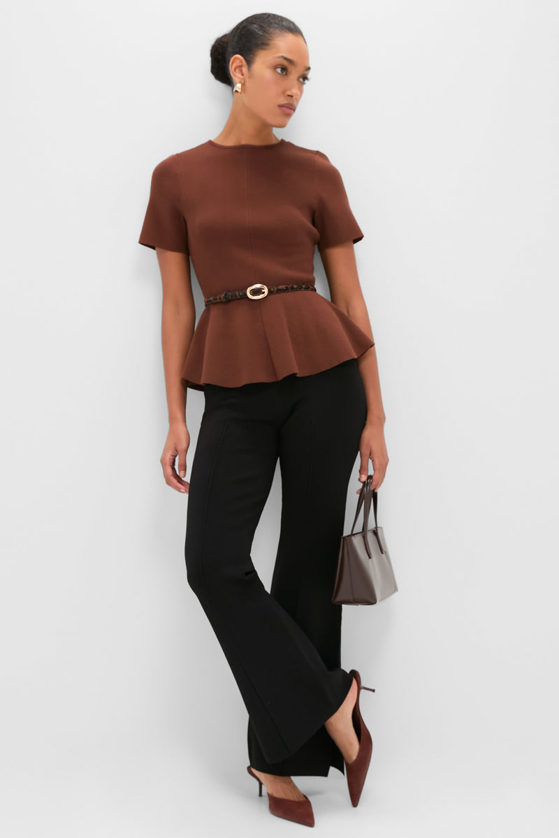 Model wearing a classic, effortless look featuring the Leopard Haircalf Oval Buckle Skinny Belt, cinching a chic peplum top, paired with high-end accessories.