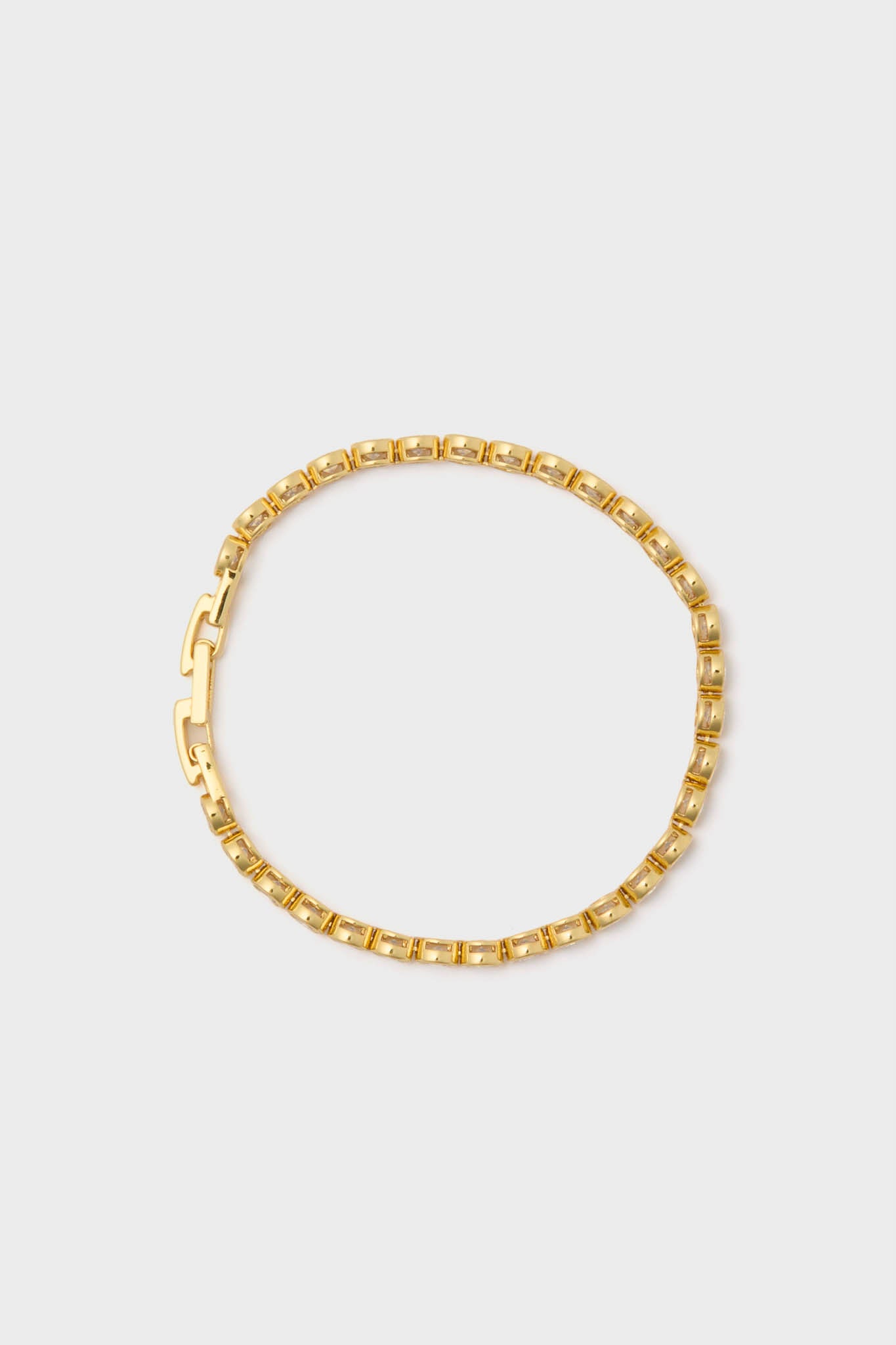 Classic Gold Bezel Tennis Bracelet with box-style links and a fold-over clasp, offering effortless elegance and fun glamour, perfect for high-end wristwear.