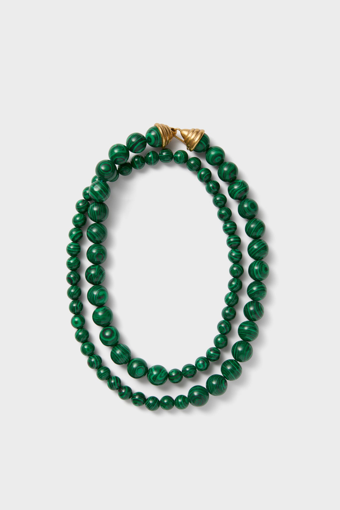 Malachite Double Strand Celine Necklace: A classic, effortless design with polished green beads and gold-tone closures, offering high-end versatility for a fun, confident style.