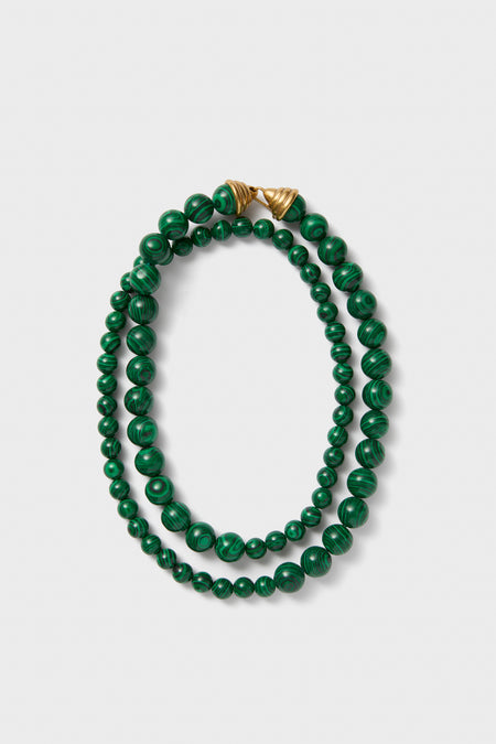 Malachite Double Strand Celine Necklace: A classic, effortless design with polished green beads and gold-tone closures, offering high-end versatility for a fun, confident style.