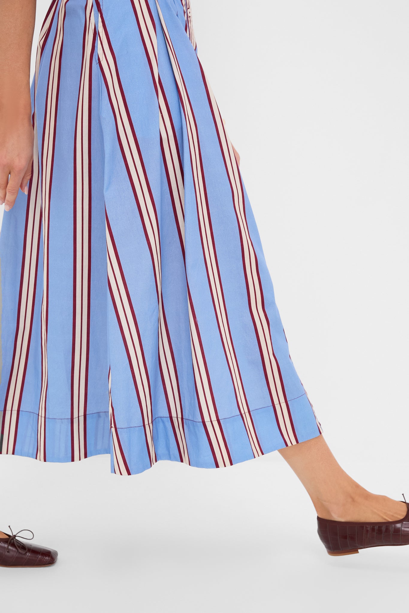 Striped Mirante Shirt Dress: A classic, effortless piece featuring vertical stripes and side seam pockets, styled with burgundy flats for a fun, high-end look.