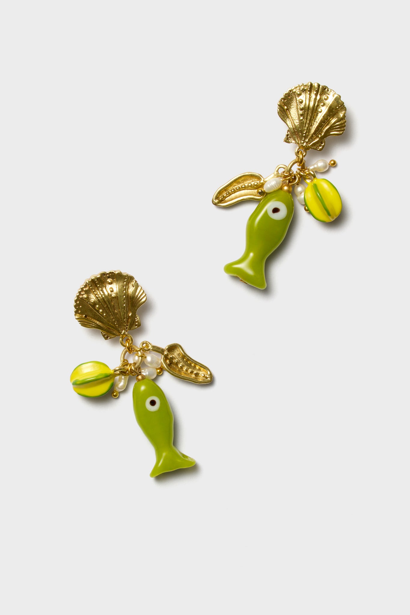 Alemais ocean-inspired fish earrings feature gold shell shapes, green and yellow fish charms, yellow bead accents, and small freshwater pearls.