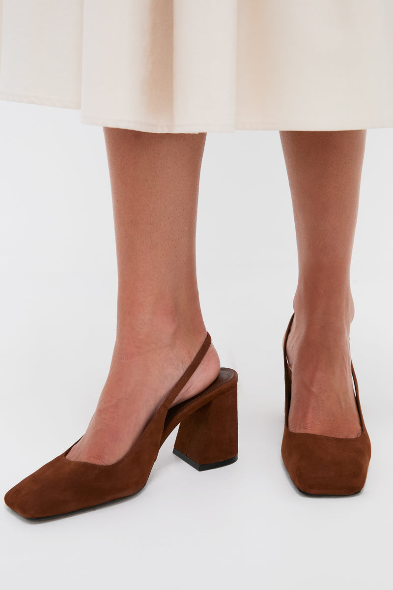Model wearing Pecan Brown Leia Block Sling Back Heels, showcasing their classic suede design and square toe, paired effortlessly with a cream midi skirt for a high-end, fun look.