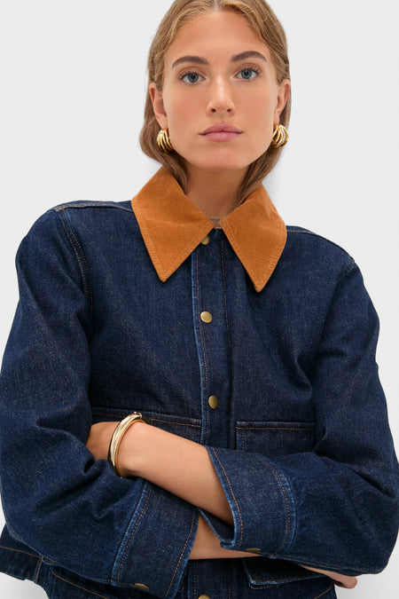 Model wearing the Midnight Rinse Denim Swingy Jacket with a classic corduroy collar, showcasing effortless style with gold accessories against a high-end, fun backdrop.