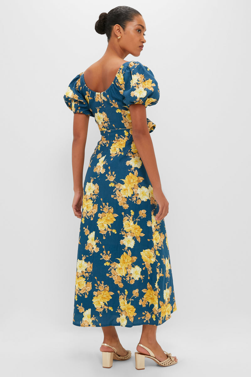 Nora Floral Navy Leiria Midi Dress features classic elegance with an effortless fit-and-flare silhouette, puff sleeves, and a fun floral pattern, perfect for high-end occasions.