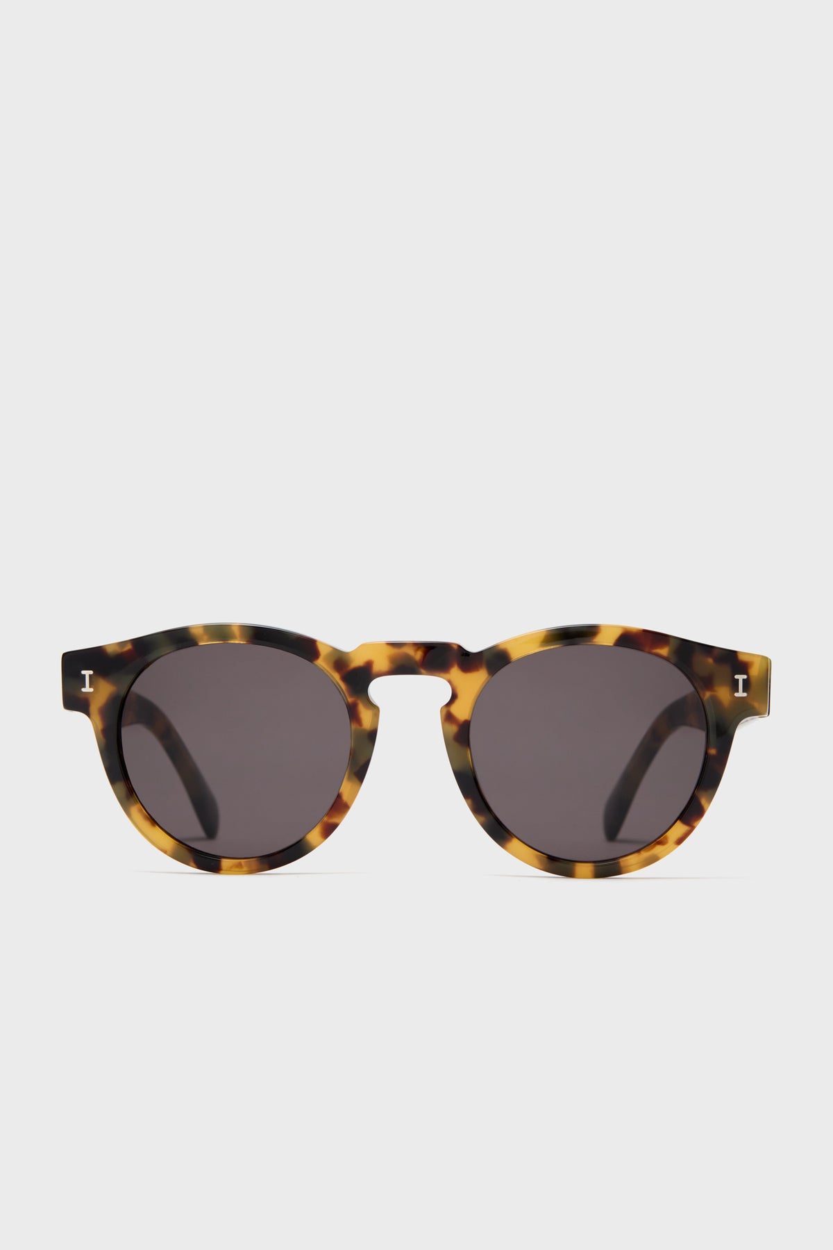 Illesteva Leonard round sunglasses featuring dark lenses and a tortoise frame, handmade in Italy.