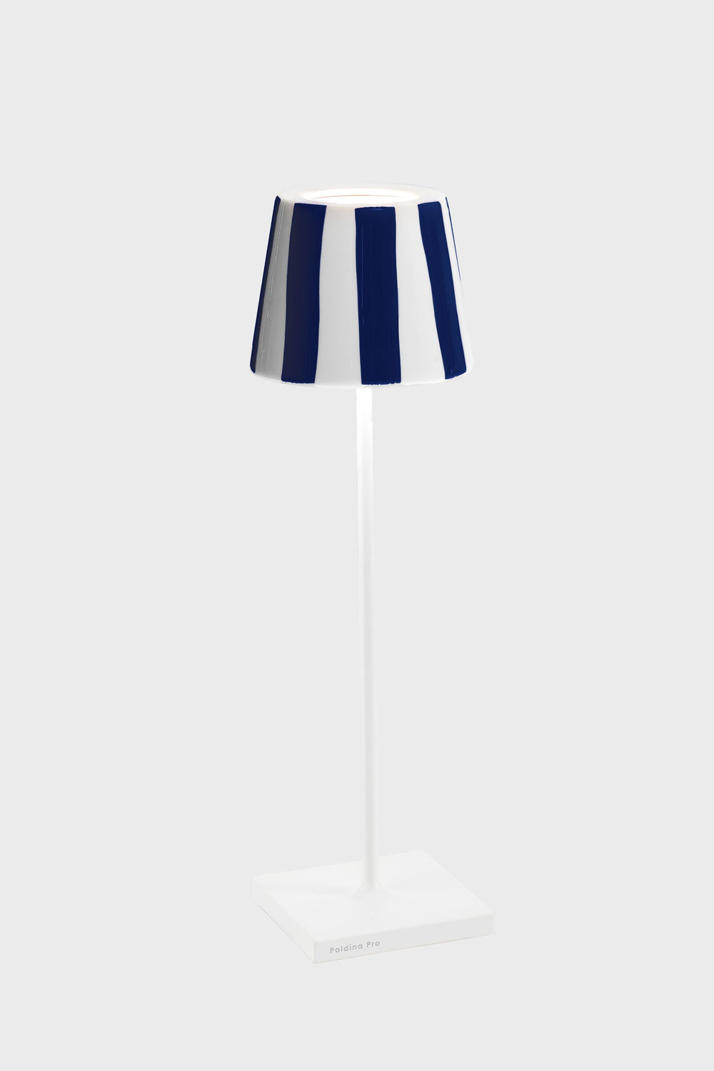 The Zafferano table lamp features Italian design with a slim white stand, square base, and a blue and white striped shade, inspired by the Poldina Pro style.