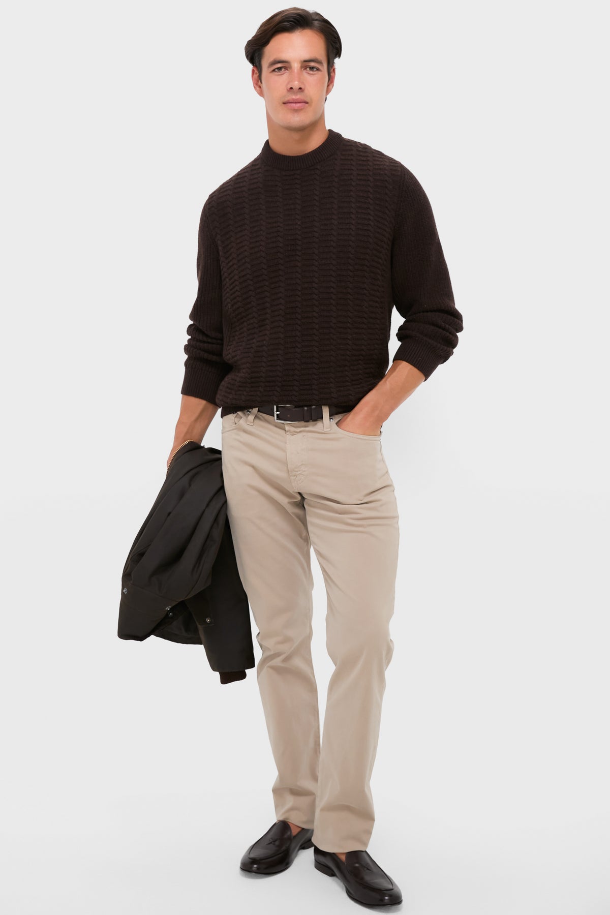 Young man in a classic, high-end Dark Oak Cleveland Crew Neck Sweater, exuding effortless style with slim-fit chinos and loafers, embodying a fun, confident look.