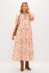 Woman in the Saffron Floral Cisco Maxi Dress, with classic puff sleeves and flowy silhouette, styled with a brown leather bag and boots, exuding effortless, high-end charm.
