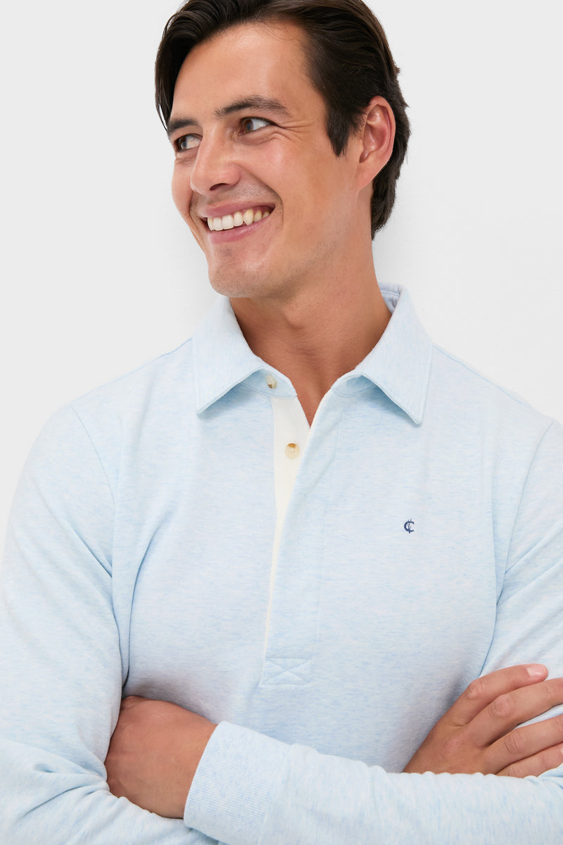Young man in an effortless, classic Heathered Ice Collared Sweatshirt by Criquet, featuring a polo design with rugby details and a casual vibe.