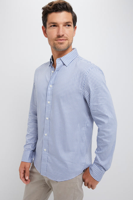 Man in classic Light Blue Gingham Movement Shirt and light khaki trousers, embodying effortless style and fun, ready for any adventure with high-end, wrinkle-free stretch fabric.