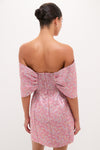Model wearing the classic Pink Multi Jacquard Off-the-Shoulder Kara Midi Dress, featuring an effortless bow detail at the back, epitomizing high-end fun and sophistication.