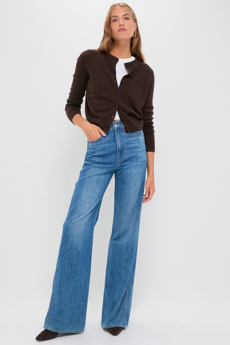 Model in French Kiss Taylor High Rise Wide Leg jeans, styled with a dark cardigan and tee, exemplifying classic, effortless fashion with a fun, high-end touch.