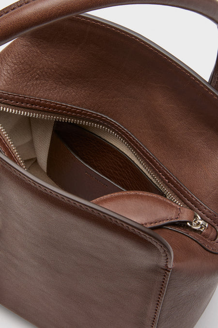 Dark Brown Leather Sporty Lady Bag with classic one-handle design, partially open top zipper, revealing light-canvas lining and interior pocket. Effortless, fun, high-end accessory.