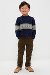 Boy in a classic Fairisle Collar Sweater, navy with geometric patterns, paired effortlessly with corduroy pants and boat shoes. Fun, high-end style for all occasions.