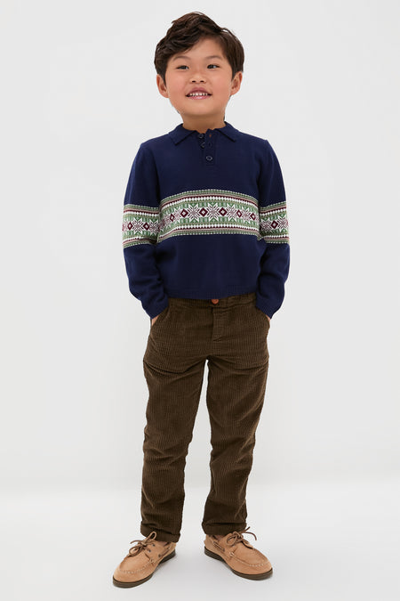 Boy in a classic Fairisle Collar Sweater, navy with geometric patterns, paired effortlessly with corduroy pants and boat shoes. Fun, high-end style for all occasions.