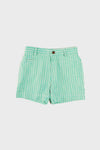 Green and white vertically striped shorts from Pepa London, made of 100% cotton with button closure, belt loops, and a front pocket, shown on a plain white background.
