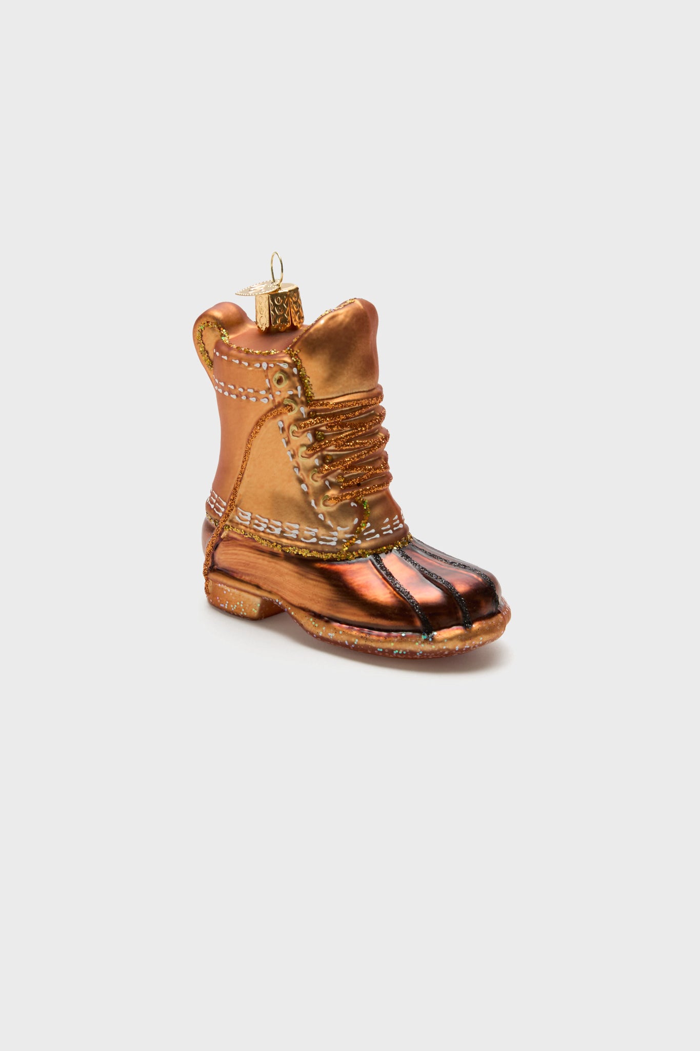 The Old World Christmas Field Boot ornament features a shiny brown and copper boot shape with a top loop for hanging—perfect for tree trimming or giving your decor an outdoorsy touch.