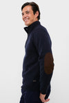 Man wearing Navy Essential Patch Half Zip Knitted Jumper with suede elbow patches and a button-up mock-neck, combining classic style with effortlessly cool, high-end comfort.