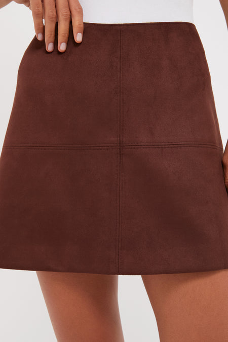 Model wearing Ganache Vegan Suede Meg Mini Skirt, showcasing classic A-line silhouette with panel stitching. Effortless style, high-end finish—fun, versatile piece for any wardrobe.