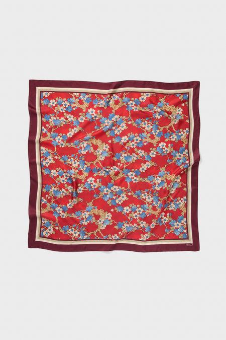 Scarlet Sakura Medium Silk Scarf, a classic accessory with stylized blossoms, offers effortless elegance and high-end versatility for a fun, chic look.