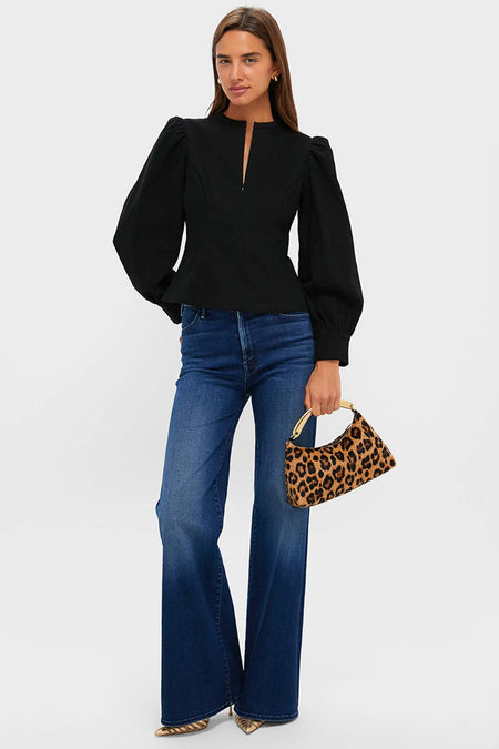 Woman wearing classic outfit with Leopard Metal Handle Rhea Bag, featuring a sleek metal top handle. Effortless, high-end style, perfect for fun, chic outings.