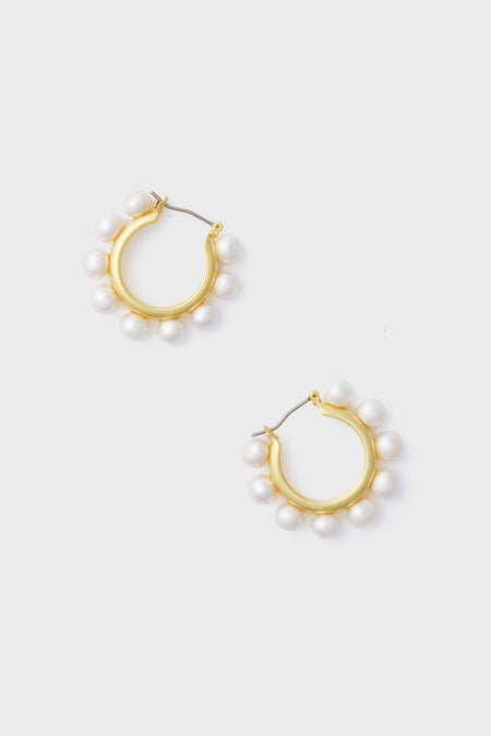 Tuckernuck Jewelry gold hoop earrings, each accented with evenly spaced white pearls, offer a refined and elegant accessory.