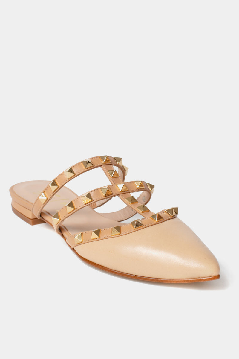 French Sole beige leather flats with a pointed toe, three gold-studded straps, and a low heel.