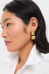 A woman with short black hair wears vintage-inspired gold plated brass hoop earrings by Tuckernuck Jewelry and a white collared shirt, shown in profile against a plain background.