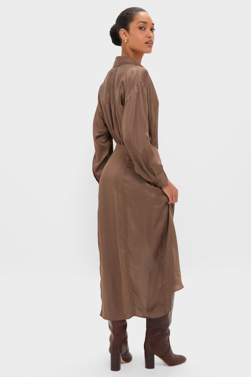 Woman models the Morel Alessandra Sarong Shirt Dress, a classic, effortless high-end piece with a wrap skirt and asymmetrical drape, paired with block-heel boots.