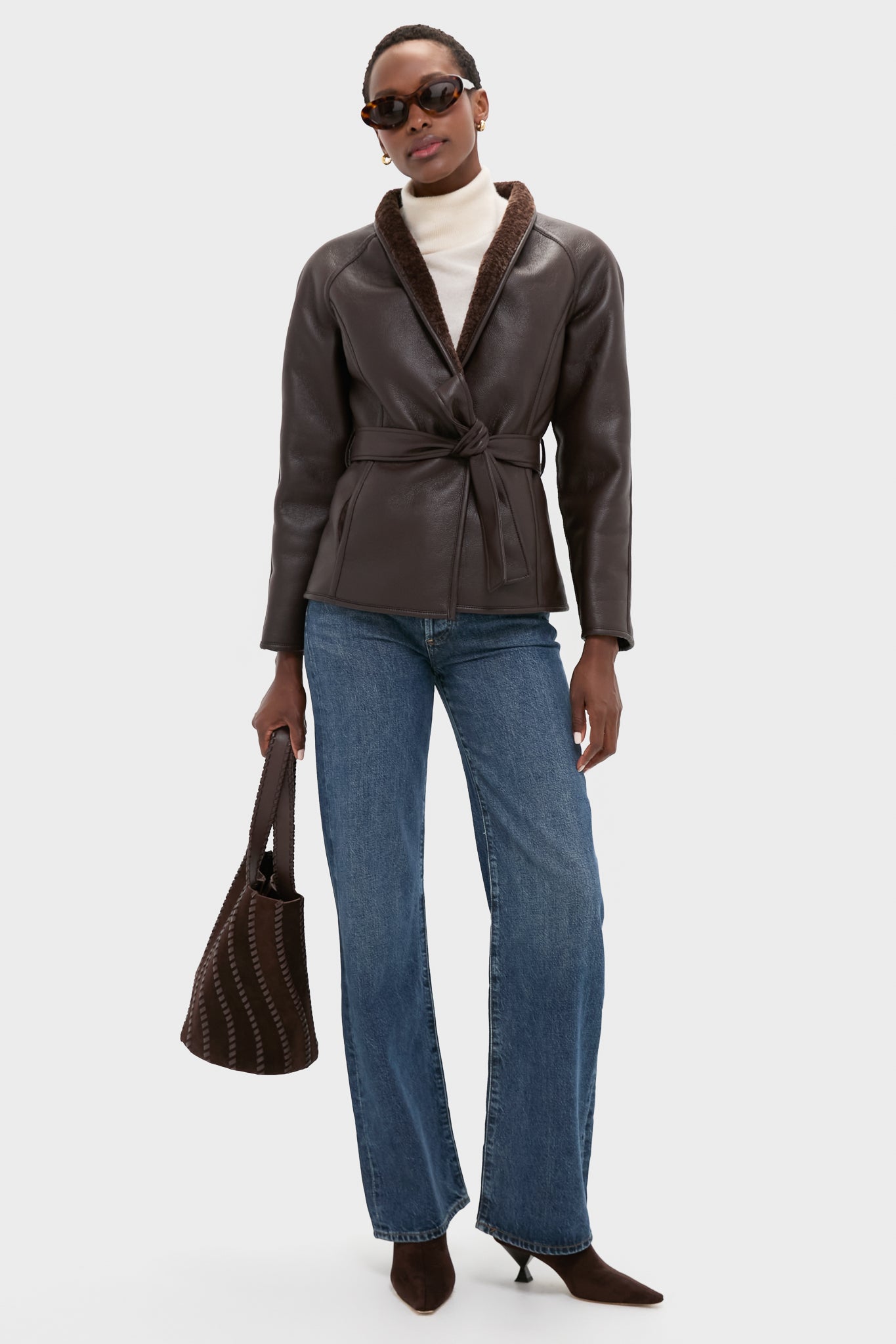 Model wearing the classic Reversible Marron Fur Coat, belted for an effortless and high-end look, paired with chic autumn wardrobe staples, including jeans and boots.