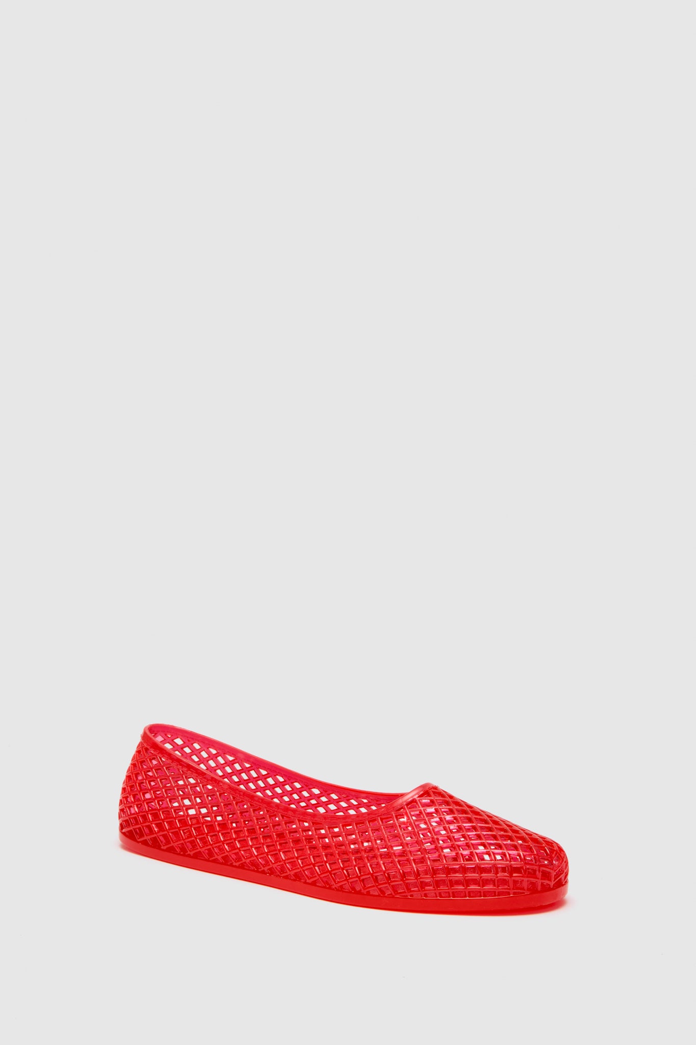 A single Ancient Greek Sandals Red Iro Jelly Flat, featuring a woven lattice design, is displayed in a plain light gray setting.
