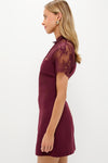 Oxblood Lace Agatha Mini Dress: A classic, effortless piece with sheer lace shoulders, perfect for a fun, high-end cocktail event. Ideal for confident, stylish occasions.