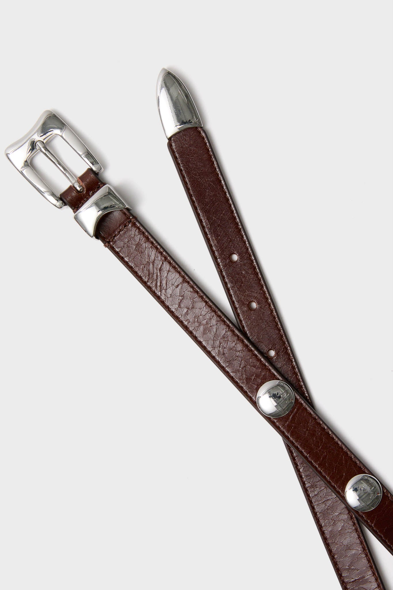 Sepia Aiden Studded Rugous Belt with polished silver buckle and conchos, offers a classic, effortless, and high-end touch, perfect for any outfit.
