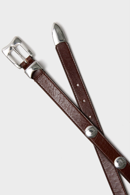 Sepia Aiden Studded Rugous Belt with polished silver buckle and conchos, offers a classic, effortless, and high-end touch, perfect for any outfit.
